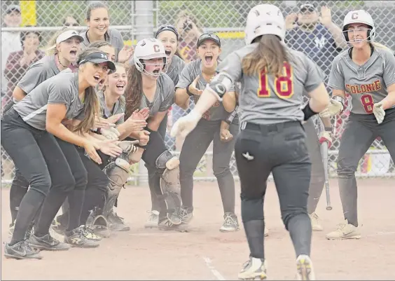  ?? Photos by Lori Van Buren / Times Union ?? Colonie’s Jaclyn Dyer gets an exuberant welcome at home plate after she hit a home run in the Section II Class AA softball final against Bethlehem.