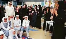  ??  ?? Shaikh Mohammad interacts with students at Zayed University in Dubai yesterday, where he launched the new scholarshi­p programme.