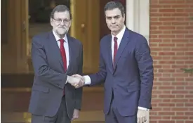  ??  ?? MADRID: Spanish caretaker Prime Minister and Popular Party (PP) leader Mariano Rajoy (left) shakes hands with the leader of Spanish Socialist Party (PSOE) Pedro Sanchez at La Moncloa palace. — AFP
