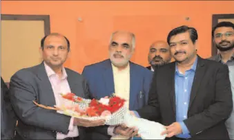  ?? - STAFF PHOTO ?? Imtiaz Hussain Chairman PAK- USA Business Council presenting the flowers to FPCCI President Engr. Daroo Khan Achakzai.