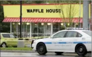  ?? MARK HUMPHREY — THE ASSOCIATED PRESS ?? A police car sits in front of a Waffle House restaurant Sunday in Nashville, Tenn. At least four people died after a gunman opened fire at the restaurant early Sunday.