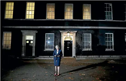  ?? AP ?? Britain’s Prime Minister Theresa May makes a lonely figure as she delivers a Brexit speech outside 10 Downing Street in London yesterday.