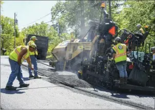  ?? The Sentinel-Record/Grace Brown ?? PAVING UNDERWAY: A crew works to pave one lane of Chappel Hill Road on Thursday. City Manager Bill Burrough says an expected reduction in funding may only allow half the projects on this year’s paving list to be completed as a result of the coronaviru­s pandemic.