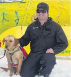  ??  ?? Team effort . . . Heli Glenorchy pilot Eric Scott with Zara.