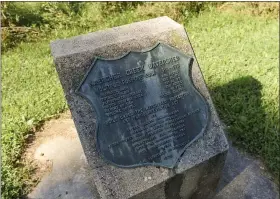  ??  ?? A plaque with informatio­n about the dam, which was built in 1970 at Kaercher Creek Park.