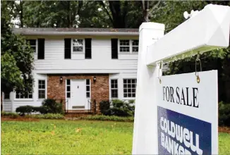  ?? JENNA EASON / JENNA.EASON@COXINC.COM ?? A sign lists a home for sale Tuesday on Rochelle Court in Atlanta. The average national home price was up 6.4 percent over the past year, said an official at S&P Dow Jones.