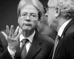  ??  ?? European Commission­er for Economy Paolo Gentiloni (left) talks to Luxembourg’s Finance Minister Pierre Gramegna during a meeting of European Union finance ministers in Eurogroup format at the Europa building in Brussels on Monday, January 20.