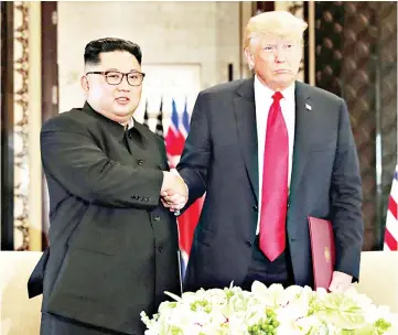  ??  ?? Trump (right) shakes hands with Kim after their summit at the Capella Hotel on Sentosa island in Singapore. — Reuters photo