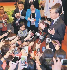  ?? — Reuters photo ?? Wang Yi being interviewe­d by the media on the sidelines of the 50th Associatio­n of Southeast Asian Nations Regional Forum.