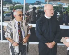  ?? Religious leaders including Rabbi Jonathan Keren- Black ( and Dean of Brisbane's St John's Cathedral Peter Catt outside Adani's Townsville offices yesterday. ?? left)