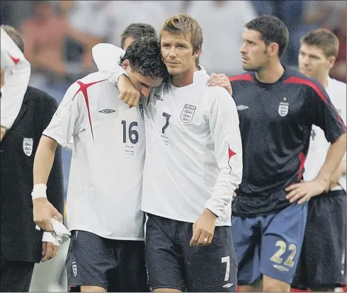  ??  ?? Captain David Beckham consoles Owen Hargreaves after England’s loss to Portugal in the quarter-final at the World Cup in Germany in 2006.