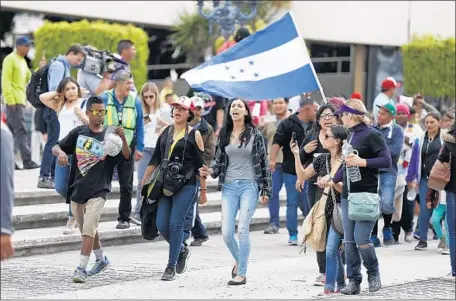  ?? Alejandro Tamayo San Diego Union-Tribune ?? CENTRAL AMERICAN immigrants and their supporters march from downtown Tijuana to the U.S.-Mexico pedestrian border in April.