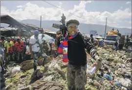  ?? Joseph Odelyn Associated Press ?? GANG LEADER Jimmy Cherizier, a.k.a. “Barbecue,” calls attention to the living conditions of ordinary Haitians in Port-au-Prince, the capital, on Friday.