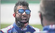  ?? MARK HUMPHREY — THE ASSOCIATED PRESS ?? Bubba Wallace talks to a crew member before the start of Sunday’s NASCAR Cup Series race at Kentucky Speedway.