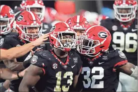  ?? AP-Brynn Anderson ?? Georgia linebacker Azeez Ojulari (13) celebrates with teammates after a sack during the second half of the team’s NCAA college football game against Mississipp­i State, Saturday, Nov. 21, 2020, in Athens, Ga.