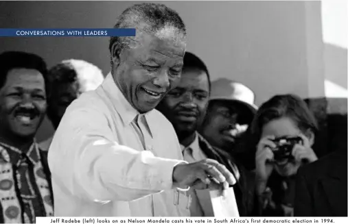  ??  ?? Jeff Radebe (left) looks on as Nelson Mandela casts his vote in South Africa's first democratic election in 1994.