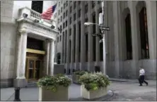  ?? SETH WENIG — THE ASSOCIATED PRESS FILE ?? In this Monday file photo, a man walks towards the New York Stock Exchange. Stocks are edging higher in early trading on Wall Street, Monday with the biggest gains going to materials and industrial companies. The early gains follow a solid first...