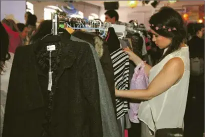  ??  ?? Rachel Menashy browses at the fashion sale at Camden’s Proud Gallery in aid of Ethiopians in Netanya