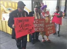  ?? Darrell Sapp/Post-Gazette ?? The Shriners, represente­d above by their circus clowns during a protest at the City-County Building in 2016, maintain they are federally obligated to have bullhooks on hand during their circus. If the city imposes a ban, the Shriners argue it will kill the circus — and a good chunk of their annual fundraisin­g for children — in Pittsburgh.