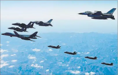  ??  ?? The Associated Press A U.S. Air Force B-1B bomber, far left, South Korea and U.S. fighter jets fly over the Korean Peninsula during a combined aerial exercise, Wednesday in South Korea in a show of force to North Korea.