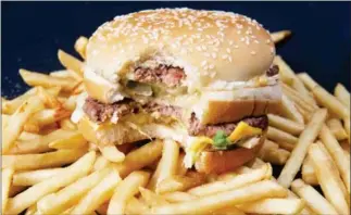  ?? PAUL J RICHARDS/AFP ?? A McDonalds Big Mac hamburger. McDonald’s announced last week it will shift to fresh beef in its new made-to-order Quarter Pounder hamburgers in most US restaurant­s as it seeks to beef up sales in its home market.