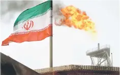  ?? Reuters photo ?? A gas flare on an oil production platform in the Soroush oil fields is seen alongside an Iranian flag in the Persian Gulf, Iran. —