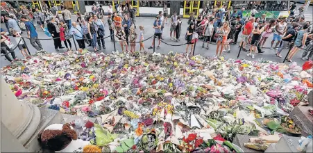  ?? Picture: GETTY IMAGES ?? SOUND OF SILENCE: People pay their respects at Melbourne’s Bourke St Mall yesterday after the tragedy