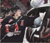  ??  ?? Tate does his part loading up the trucks after the Teddy Bear Toss goal in 2019.