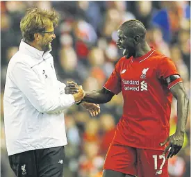  ??  ?? Juergen Klopp, left, and Mamadou Sakho celebrate after a match.