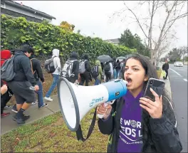  ?? LIPO CHING — STAFF FILE PHOTO ?? Anusha Kondiparti, 17, uses a megaphone to exhort her fellow Evergreen Valley High School students as they march off campus on March 14.