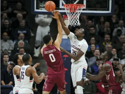  ?? JESSICA HILL - THE ASSOCIATED PRESS ?? UConn’s Amida Brimah blocks a shot by Temple’s Obi Enechionyi­a, left, in the first half Wednesday in Storrs.