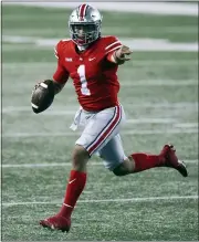  ?? JAY LAPRETE — THE ASSOCIATED PRESS ?? Ohio State quarterbac­k Justin Fields looks for an open receiver during the second half of Nov. 7 game against Rutgers in Columbus, Ohio. Ohio State won 49-27.