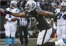  ??  ?? In this Nov. 27, 2016, file photo, Oakland Raiders defensive end Khalil Mack (52) scores a touchdown after intercepti­ng a pass from Carolina Panthers quarterbac­k Cam Newton (1) during the first half of an NFL football game in Oakland. AP PHOTO/TONY AV