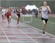  ?? PHOTO BY PAUL CONNORS — MEDIA NEWS GROUP/BOSTON HERALD ?? Walpole’s Luke Zahurak, right, leads the field of runners across the finish line to win the boys one mile race during the South Shore Twilight Invitation­al.