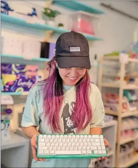  ?? COURTESY OF TINY KEYBOARD SHOP ?? Tiny Keyboard Shop owner “Tiny,” who didn't divulge a last name, holds a keyboard shortly after opening the shop in San Jose in August 2022. The site offers customizab­le keyboards.