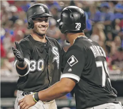  ?? | AP ?? The Sox’ Nicky Delmonico is congratula­ted by teammate Jose Abreu after hitting a two- run home run in the sixth inning Friday.