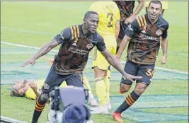  ?? Mark Humphrey / Associated Press ?? Dynamo defender Maynor Figueroa, center, celebrates after scoring the tying goal on a header in the 89th minute vs. Nashville SC.