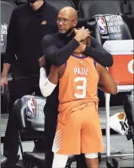  ?? Ronald Martinez / Getty Images ?? Coach Monty Williams of the Phoenix Suns hugs Chris Paul (3) in the final seconds of the team’s win against the L.A. Clippers during the second half in Game 6 of the Western Conference Finals at Staples Center on June 30 in Los Angeles.