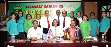  ??  ?? Sajali (seated centre) in a group photo with Koperkasa members and staff including Kadir (seated left) and Rumi (seated right).