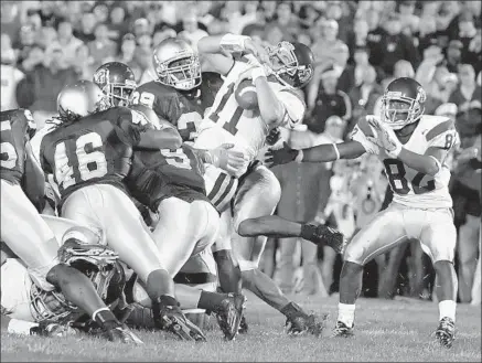  ?? Photograph­s by Alex Gallardo Los Angeles Times ?? MATT LEINART spins into the end zone with the Trojans’ game-deciding touchdown on a quarterbac­k sneak.