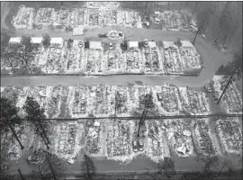  ?? Noah Berger Associated Press ?? AN AERIAL photo shows the remains of Paradise, Calif., homes leveled by the Camp fire in November 2018. Pacific Gas & Electric had sought a law’s change.