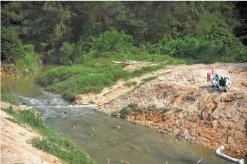  ??  ?? A file photo showing Hazmat team unit carrying out inspection­s in a pollution zone at Sungai Kim Kim in Pasir Gudang. — Bernama photo