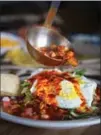  ?? SERGIO SALVADOR, TNS ?? Classic New Mexican breakfast smothered in red chiles.