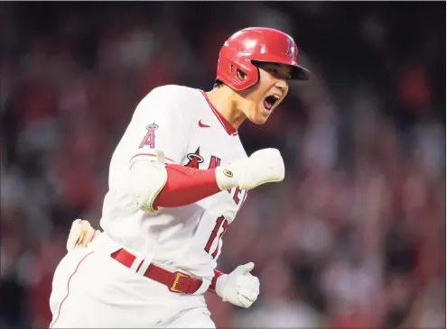  ?? Ashley Landis / Associated Press ?? Angels designated hitter Shohei Ohtani reacts as he runs the bases after hitting a two-run homer against the Orioles on July 2 in Anaheim, Calif. Ohtani, the Angels’ two-way superstar, is the winner of The Associated Press’ Male Athlete of the Year award.