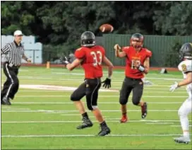  ?? ROB DUDLEY — FOR DIGITAL FIRST MEDIA ?? Penncrest quarterbac­k Chris Mills swings right for a short completion to junior running back John Cosgrove early in what became a Lions victory over Pope John Paul II.