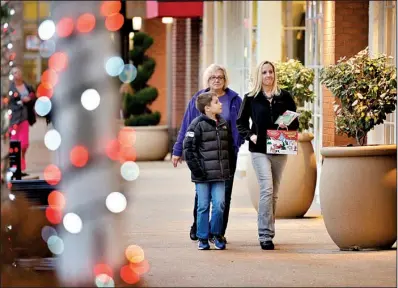  ?? NWA Media/BEN GOFF ?? Luke Greene, 9, shops last week at Pinnacle Hills Promenade in Rogers with his mother, Natalie, and his grandmothe­r Jimmie Huber.