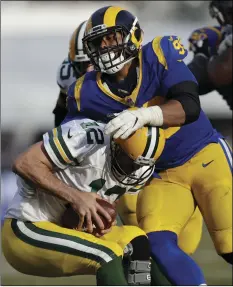  ?? PHOTO/MARCIO JOSE SANCHEZ ?? Los Angeles Rams defensive tackle Aaron Donald (above) sacks Green Bay Packers quarterbac­k Aaron Rodgers (below) during the second half of an NFL football game, on Sunday, in Los Angeles. AP