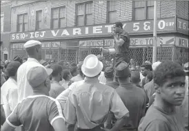  ?? AP ?? In this July 23, 1967, file photo, U.S. Rep. John Conyers, D-Detroit, uses a bullhorn as he tries to encourage African-Americans in Detroit’s riot area to go home.