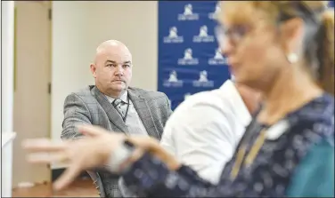  ?? (River Valley Democrat-Gazette/Hank Layton) ?? Jim Davis (left), assistant superinten­dent of secondary education for Rogers Public Schools, visits Wednesday with fellow secondary career center technical directors across Arkansas at a lunch and tour hosted by the University of Arkansas at Fort Smith’s Center for Economic Developmen­t at the Bakery District in downtown Fort Smith.