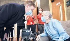  ?? STEPHEN DUNN/AP ?? Gov. Ned Lamont greets Jeanne Peters, 95, a rehab patient at The Reservoir, a nursing home facility in West Hartford, after she was given the first COVID-19 vaccinatio­n in the area. Lamont has enjoyed broad support for his handling of the coronaviru­s crisis.